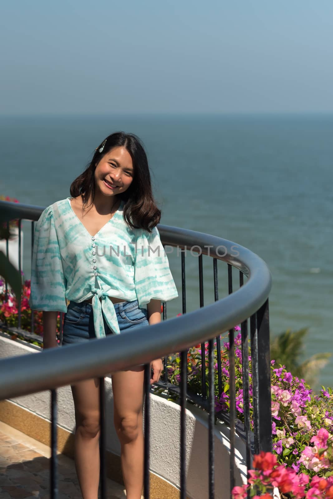Asian pretty woman relax at sea viewpoint with happy and fun emotion in concept travel, vacation, leisure in life