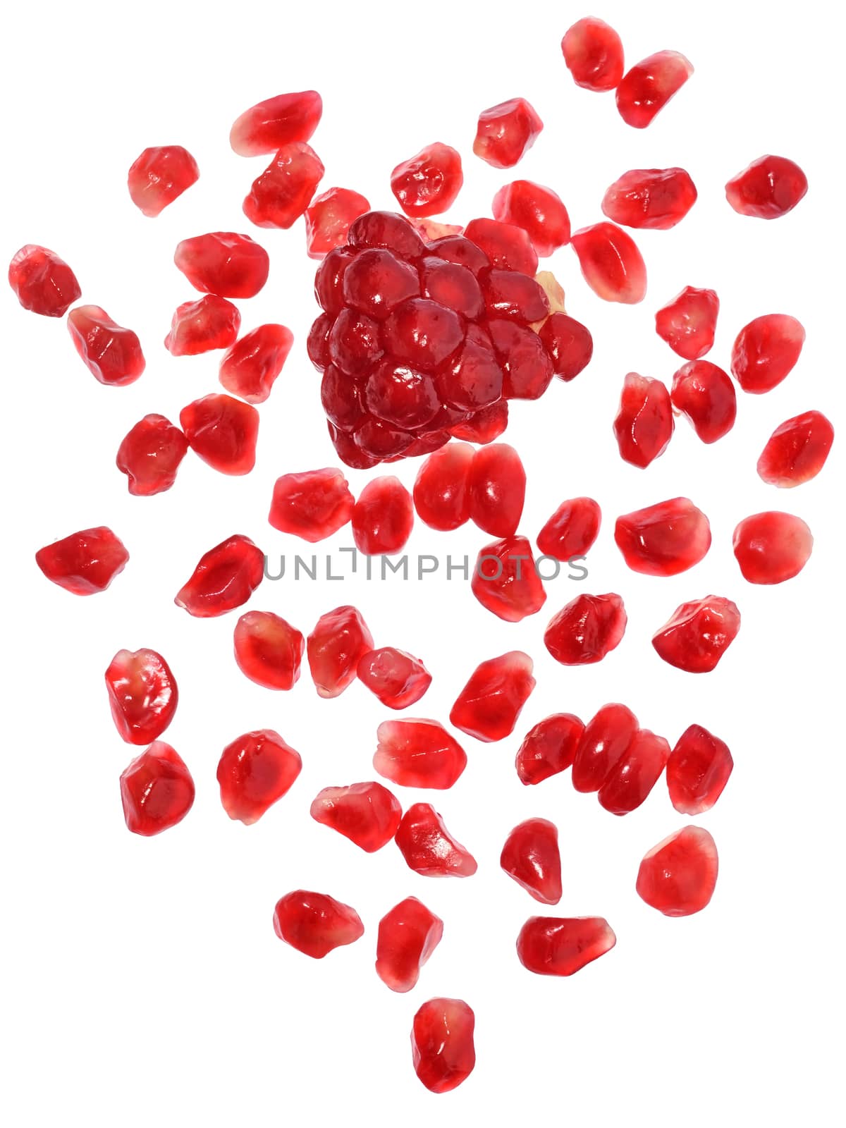 Pomegranate with scattered grain top view on white background.