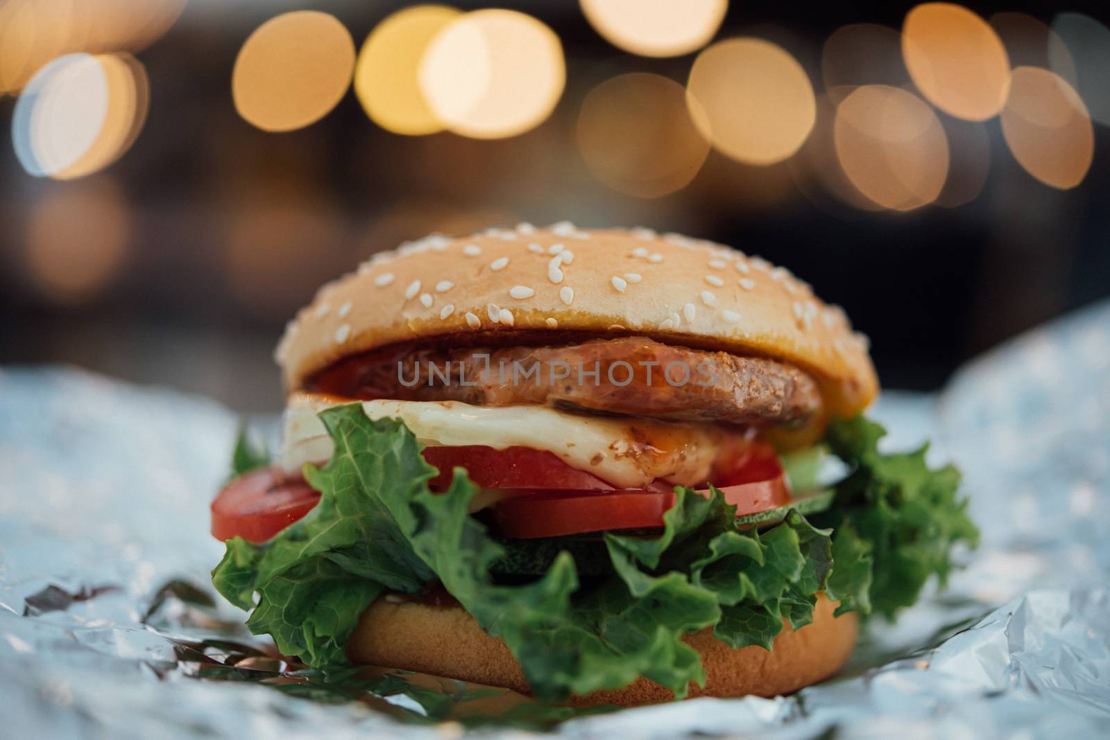 Hamburger is a fast food make from bun, meat, cheese and vegetable  in fastfood restaurant, unhealthy food or fat concept