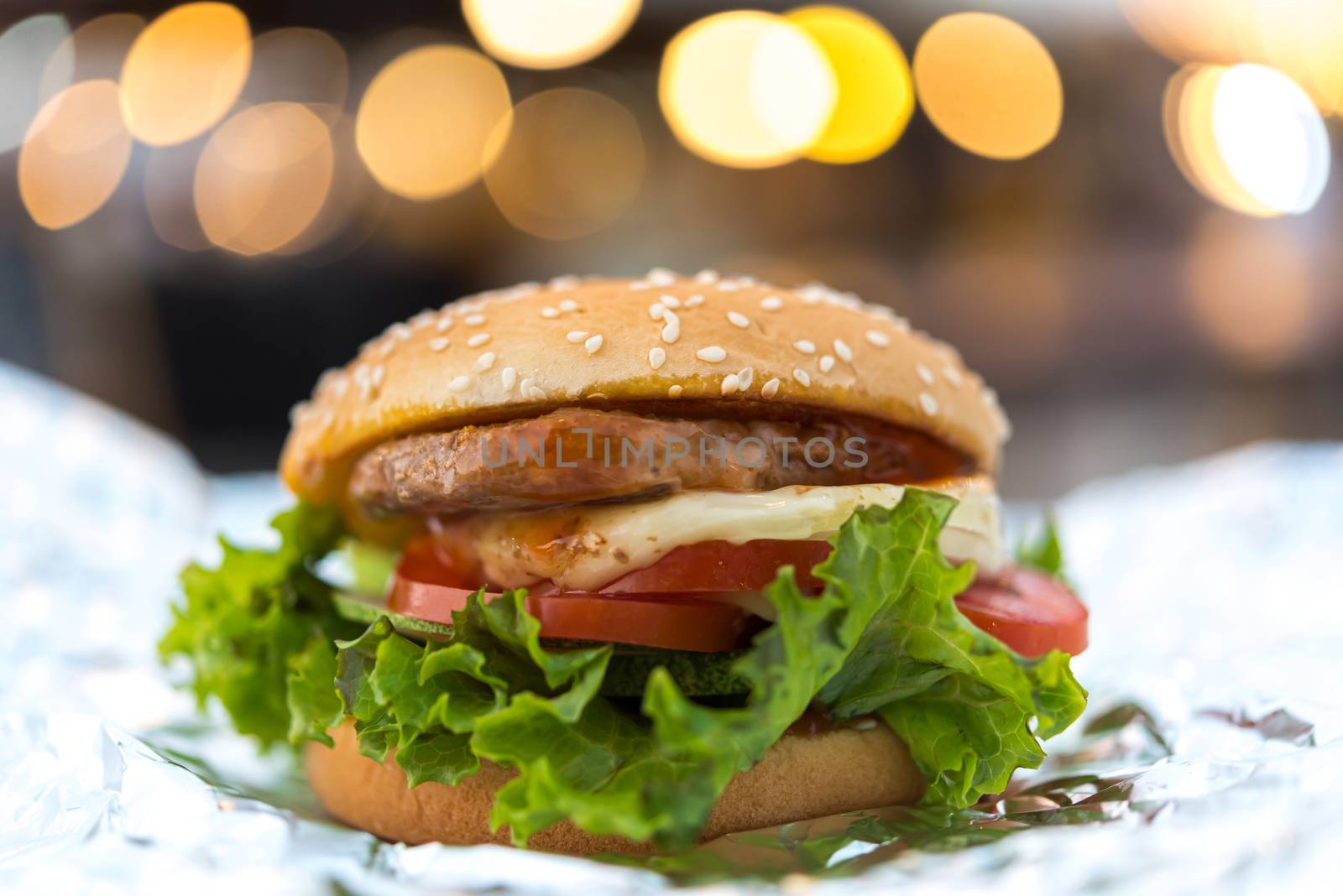 Hamburger is a fast food make from bun, meat, cheese and vegetable  in fastfood restaurant, unhealthy food or fat concept