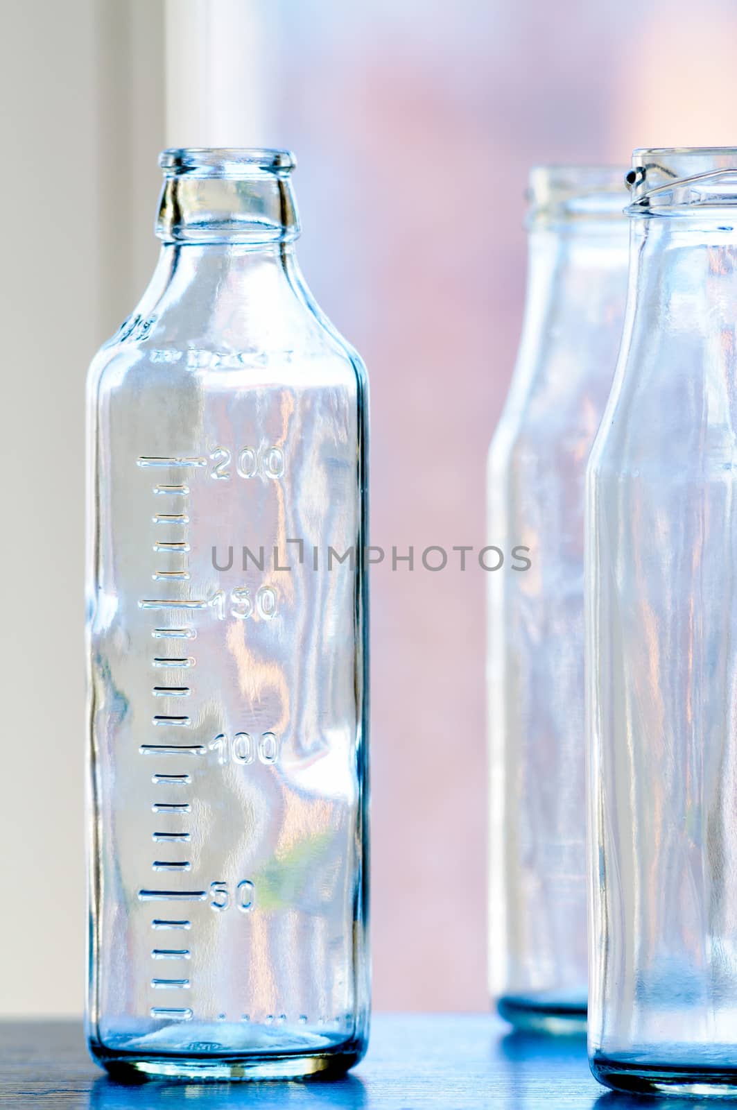 Graduated glass bottle with colorful reflections