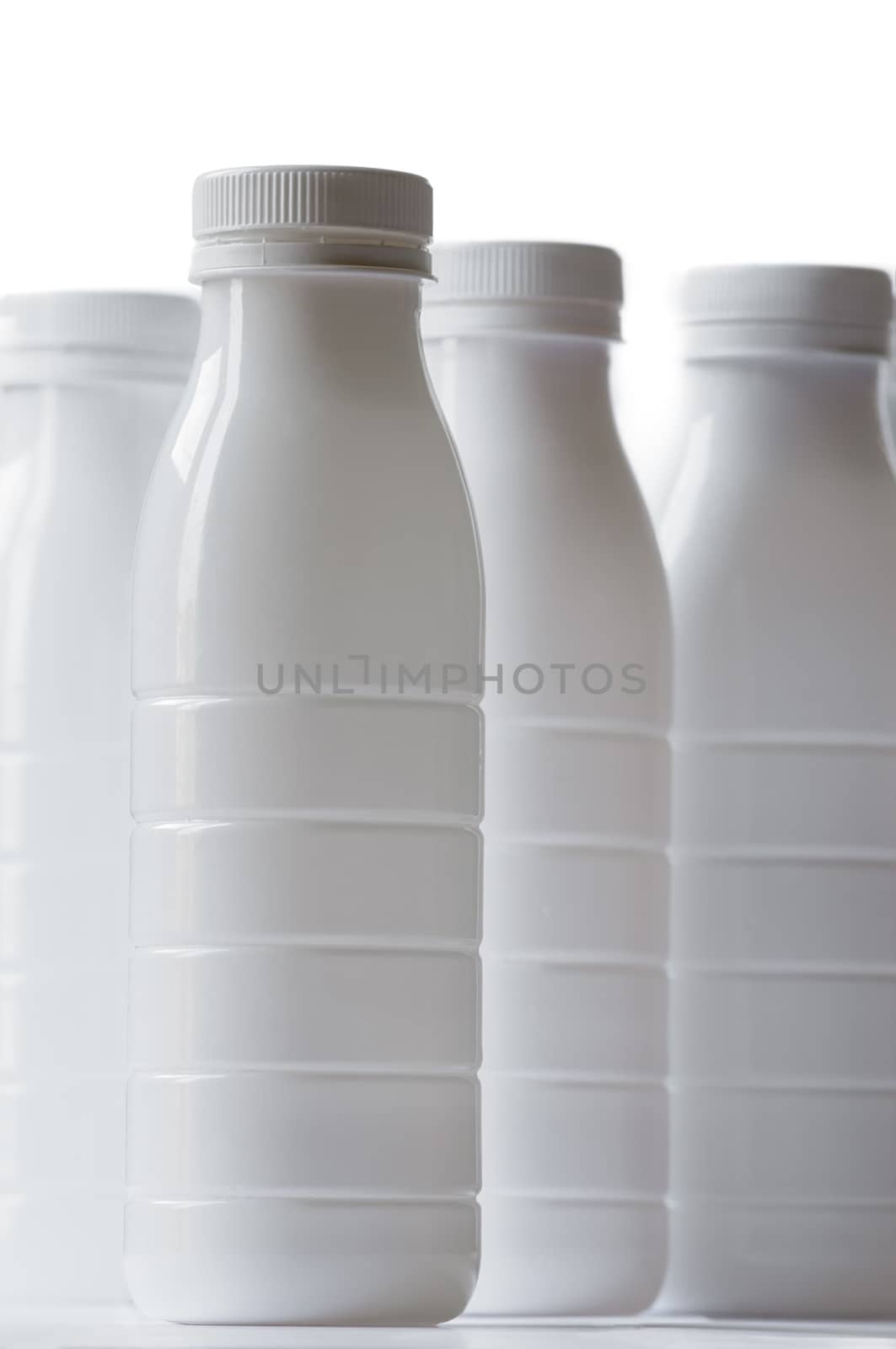 Group of white plastic milk bottle on white background