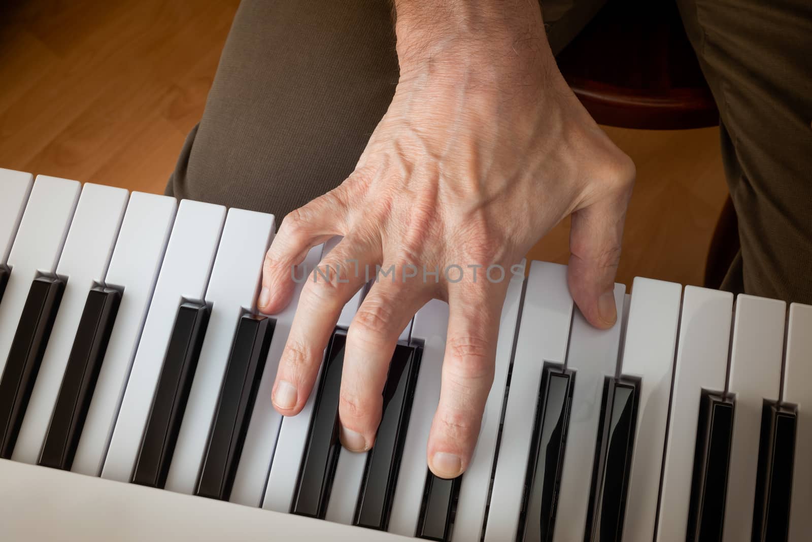 Hand of a musician playing a music keyboard by MaxalTamor