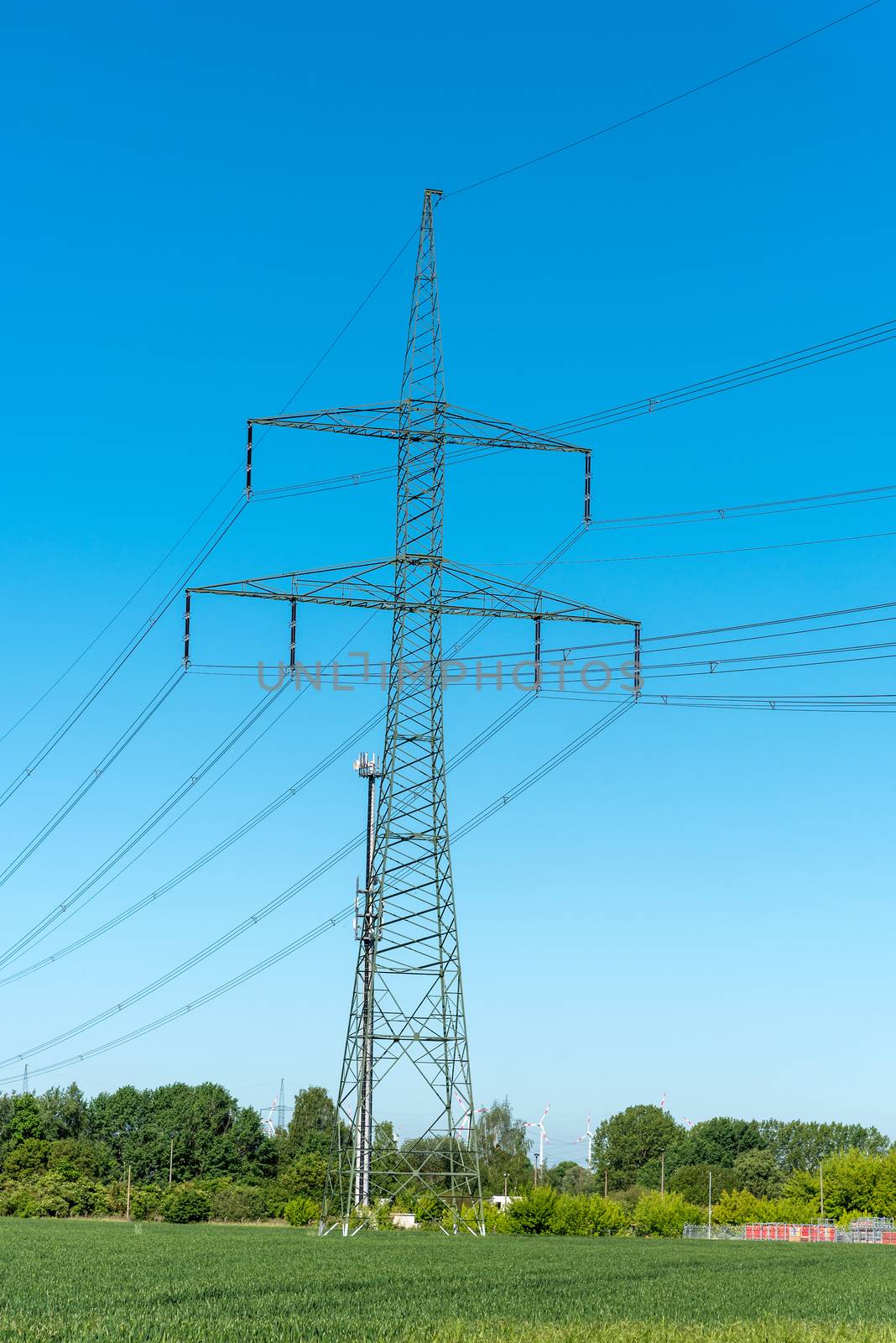 Power supply lines and electric pylons on a sunny day seen in Germany