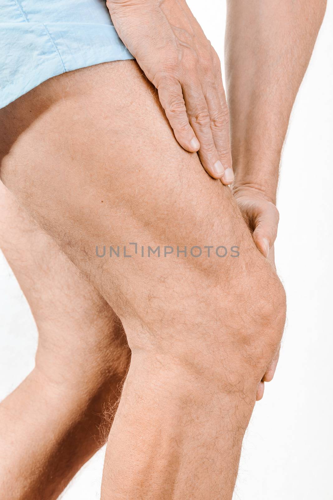 Athlete man massaging a painful  quadriceps and the knee after a sport accident. It could be a musculaire claquage, a muscle elongation, a medial meniscus tears or bursitis