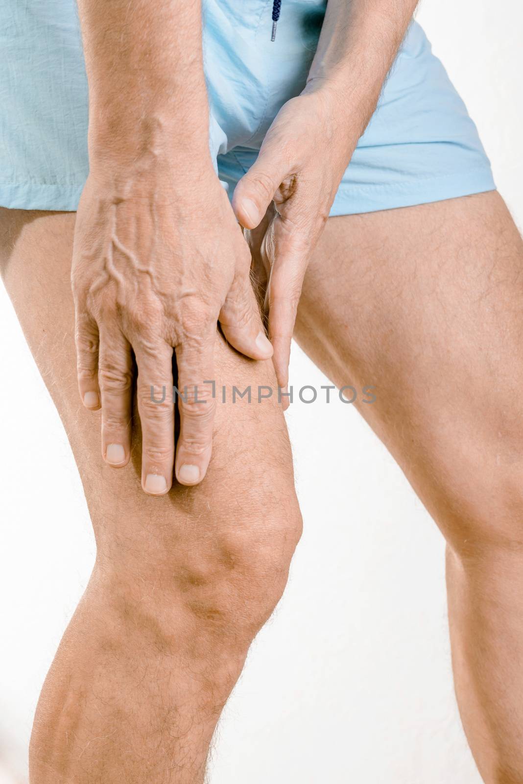 Athlete man massaging a painful  quadriceps after an accident. It could a musculaire claquage or a muscle elongation