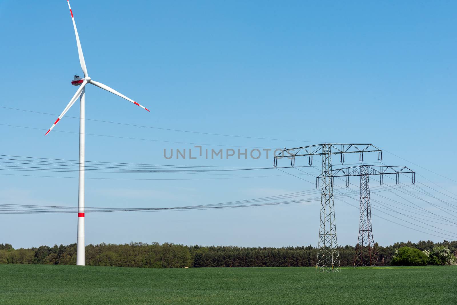 Overhead power lines and wind power plants in the fields in Germany