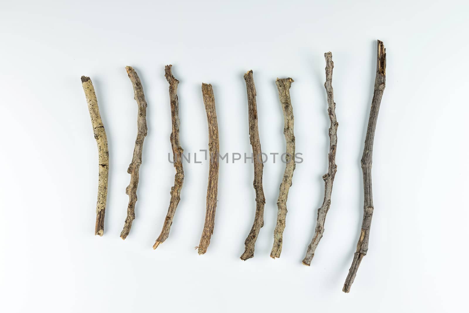 Pile of dry twigs on white background by YingTanthawarak