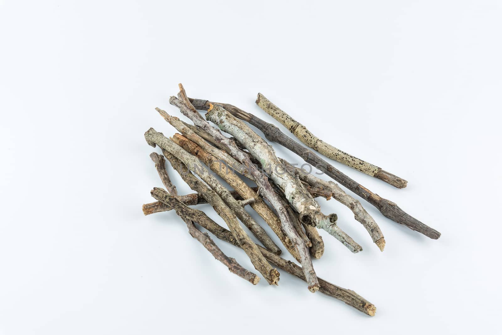 Pile of dry twigs on white background by YingTanthawarak