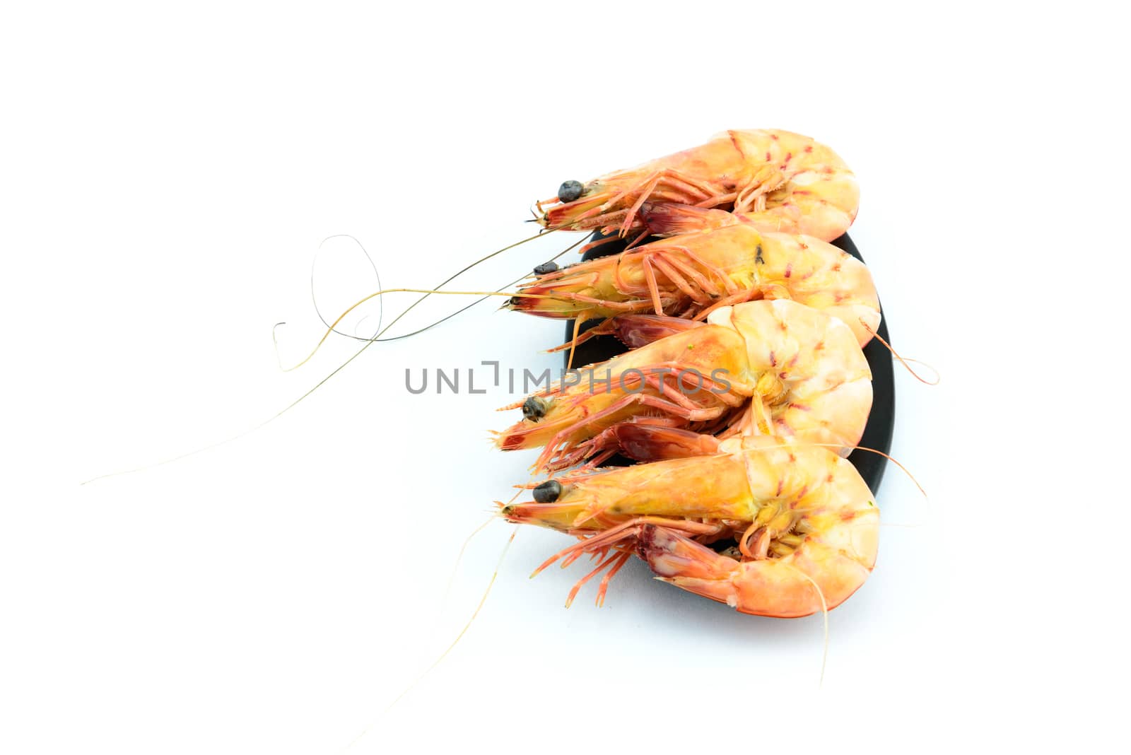 Boiled shrimp and black plate on white background by YingTanthawarak