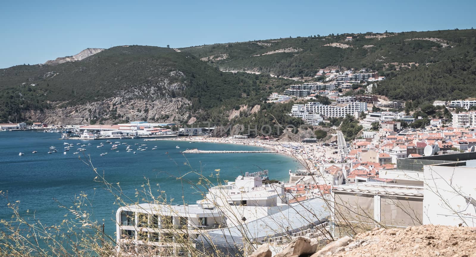 Sesimbra, Portugal - August 8, 2018: aerial overview of beaches and beach town center where tourists come to enjoy the sea on a summer day