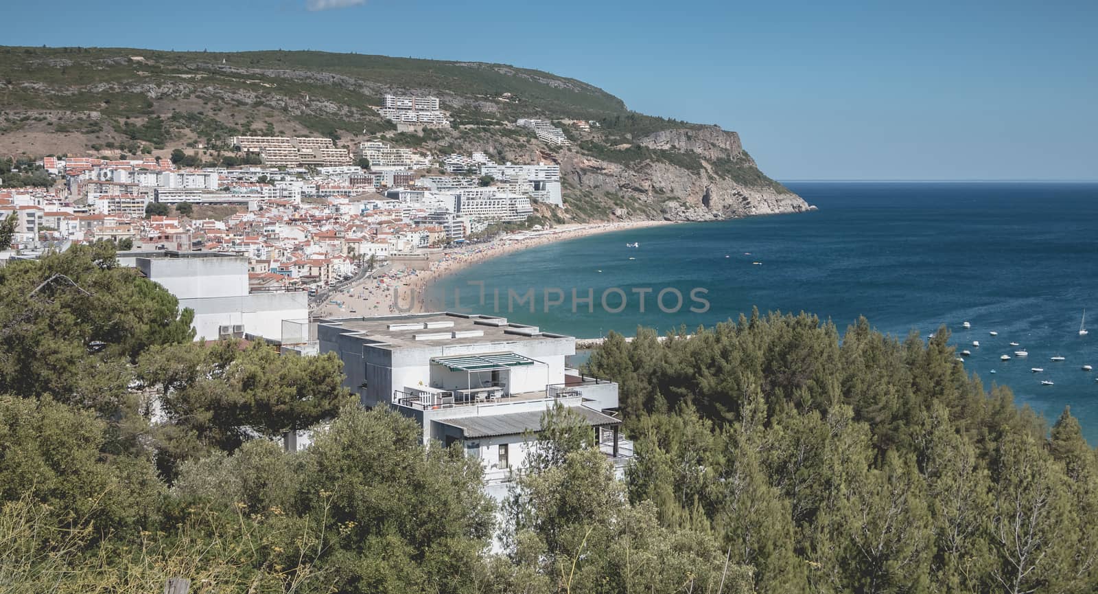 Sesimbra, Portugal - August 8, 2018: aerial overview of beaches and beach town center where tourists come to enjoy the sea on a summer day