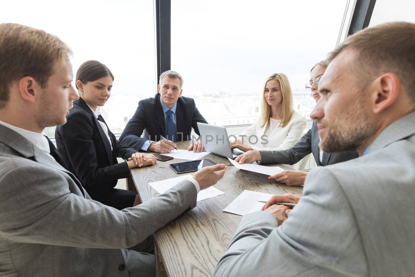Team of business people at meeting in office discuss contract terms