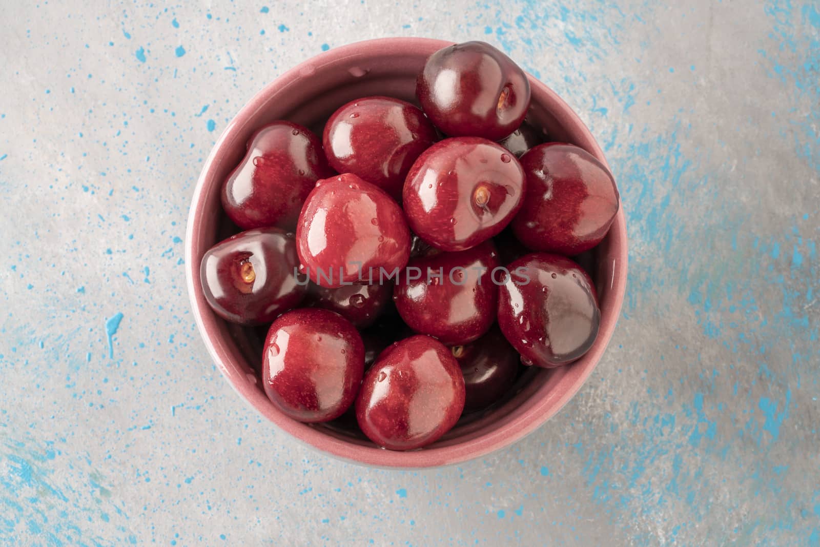closeup fresh ripe cherry fruits in a bowl on table with copy space