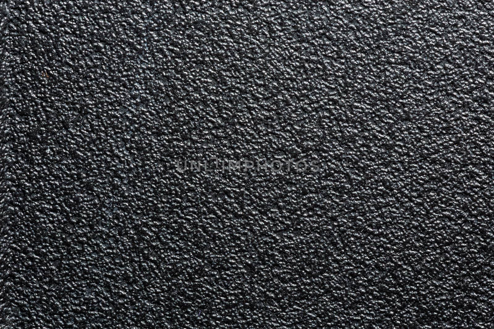 flat black rugged plastic or rubber surface with decorative bumpy finish.