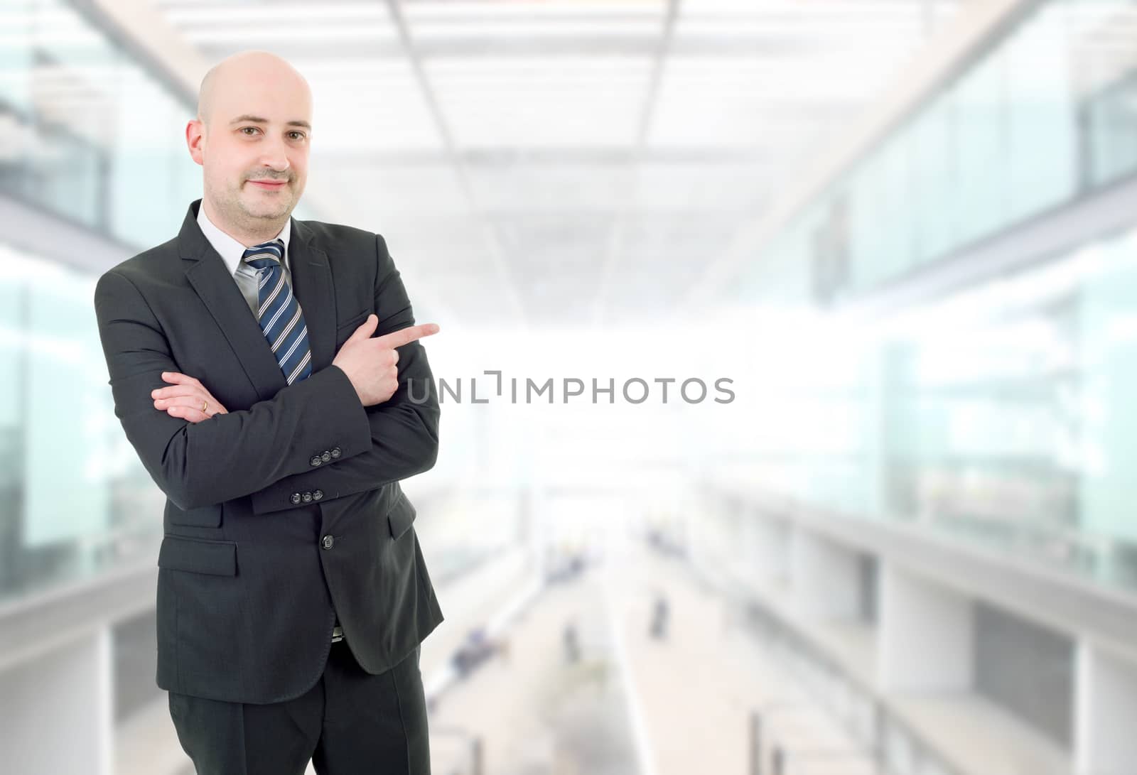 happy business man pointing, at the office