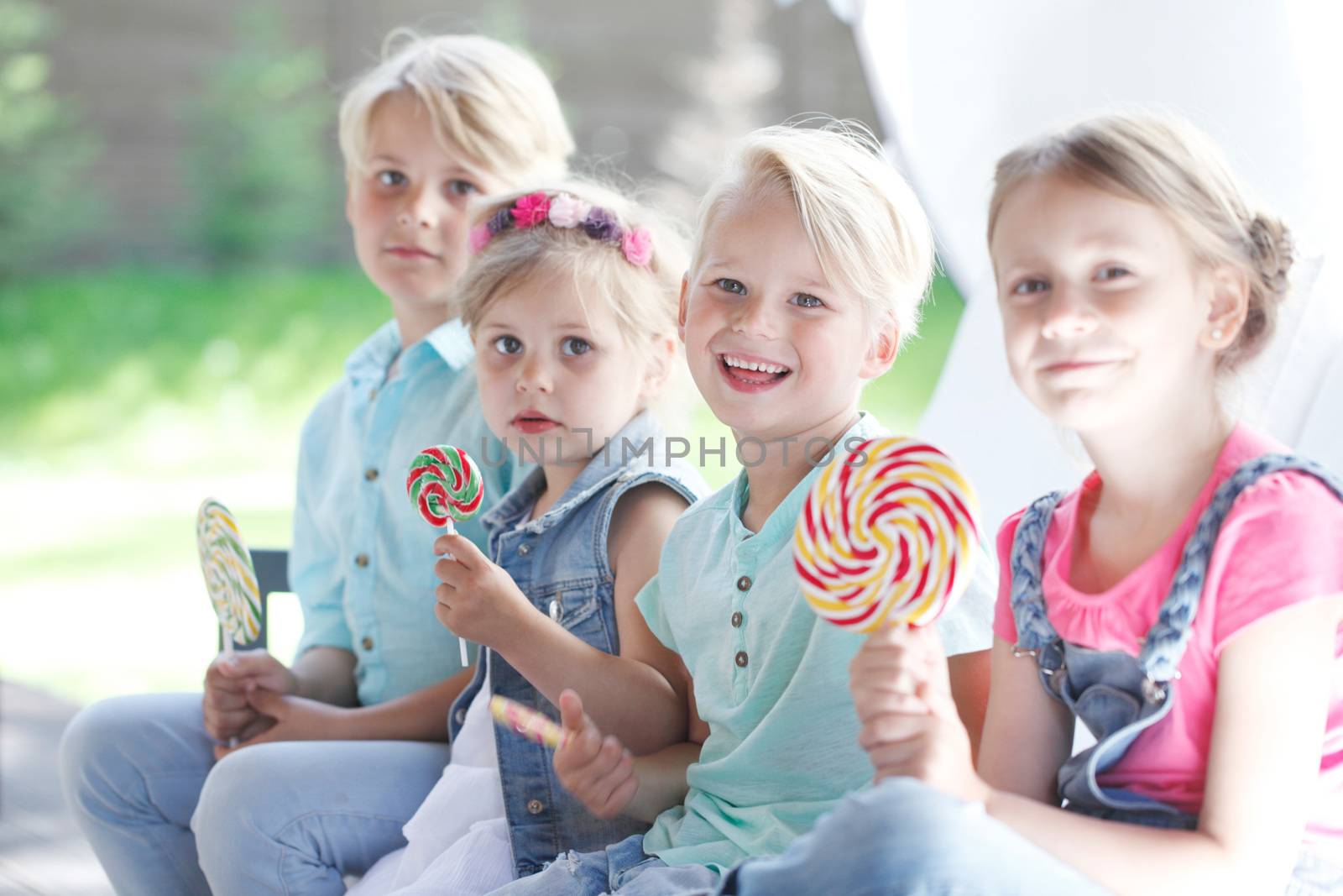 Happy children with lollipops by ALotOfPeople