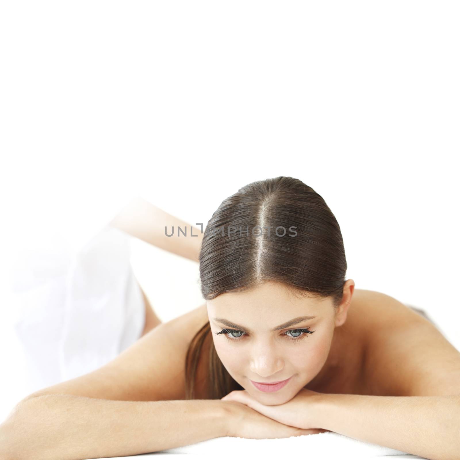 Smiling woman enjoying massage in a spa center