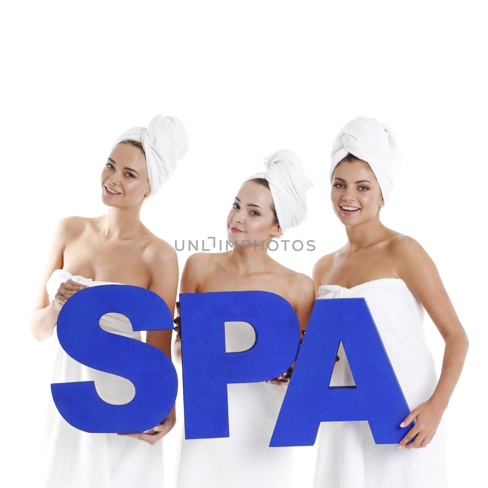 Beautiful young women holding big blue spa letters isolated on white background