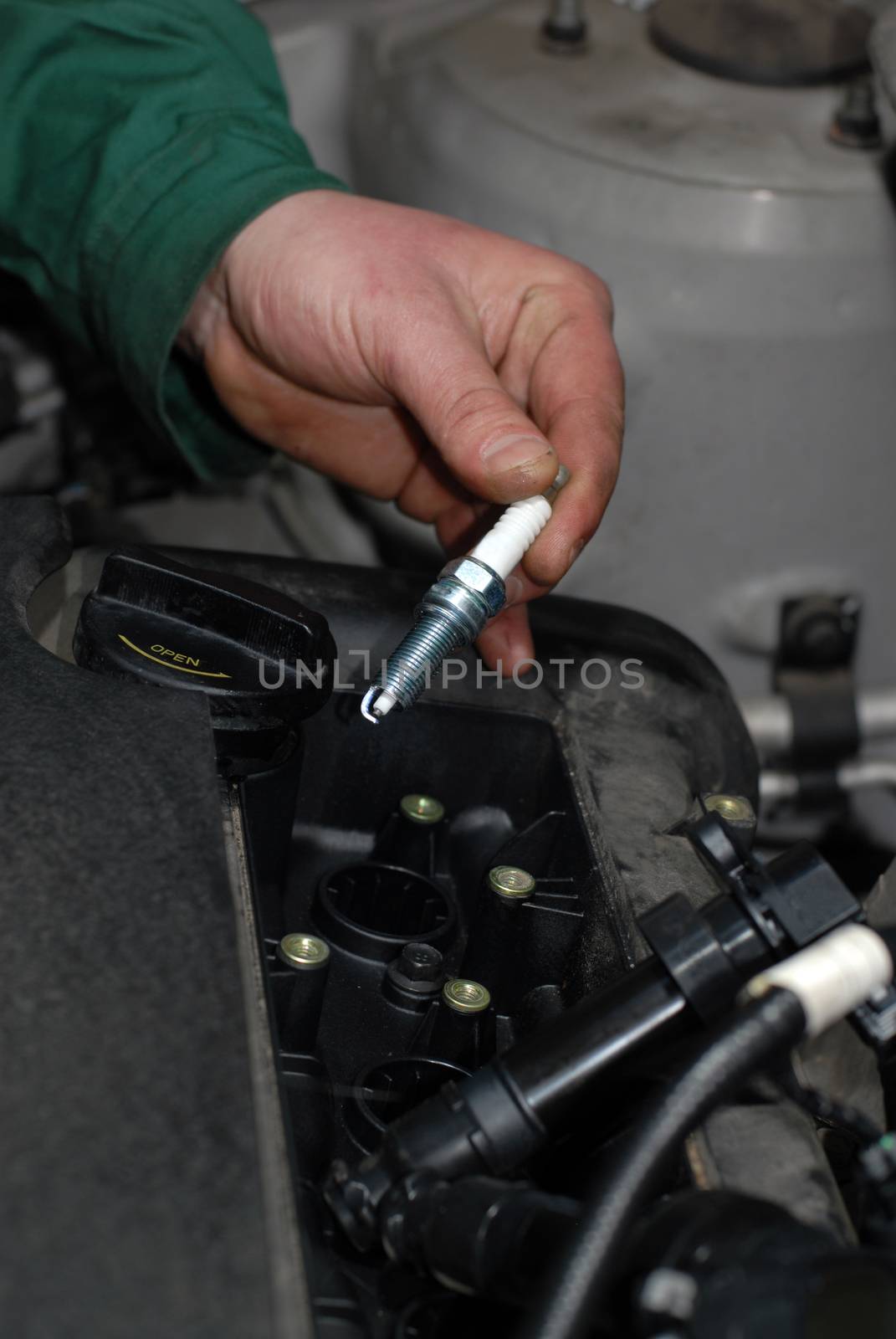 mechanic removed the old automotive spark plug