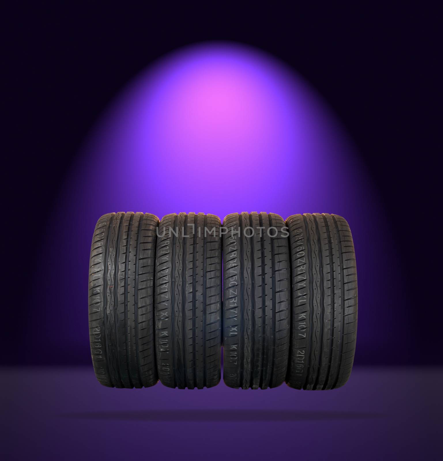 4 summer tires isolated on dark background