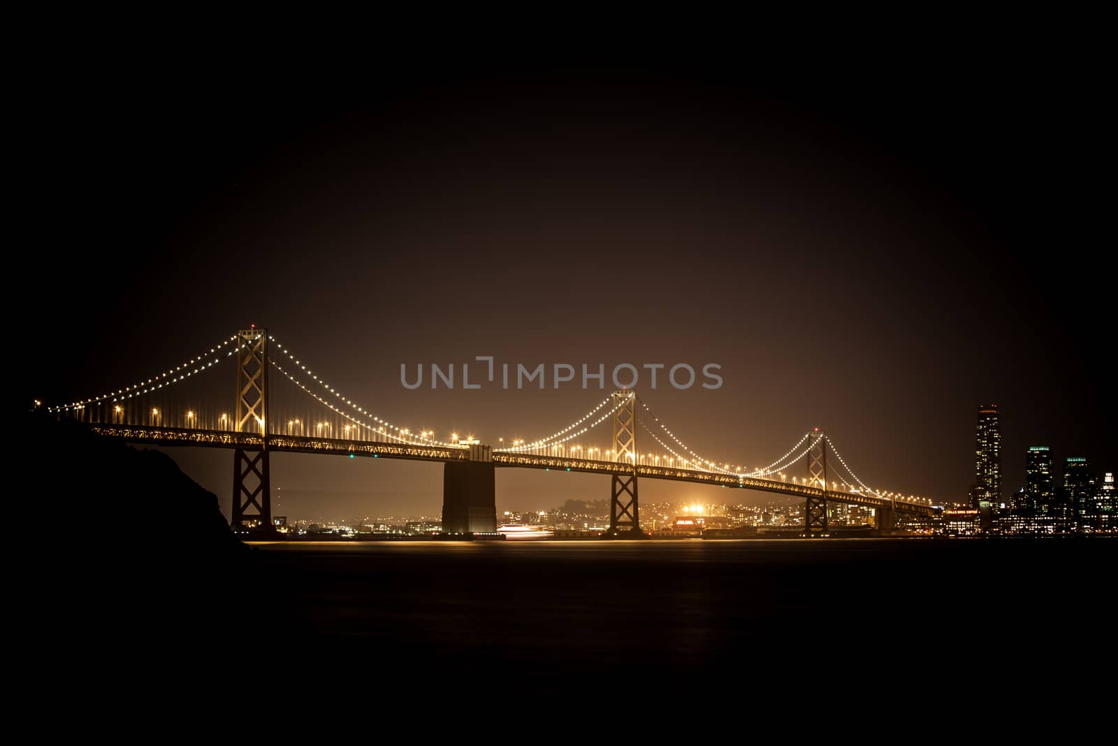 The Bay Bridge at night between Oakland and San Francisco from Treasure Island
