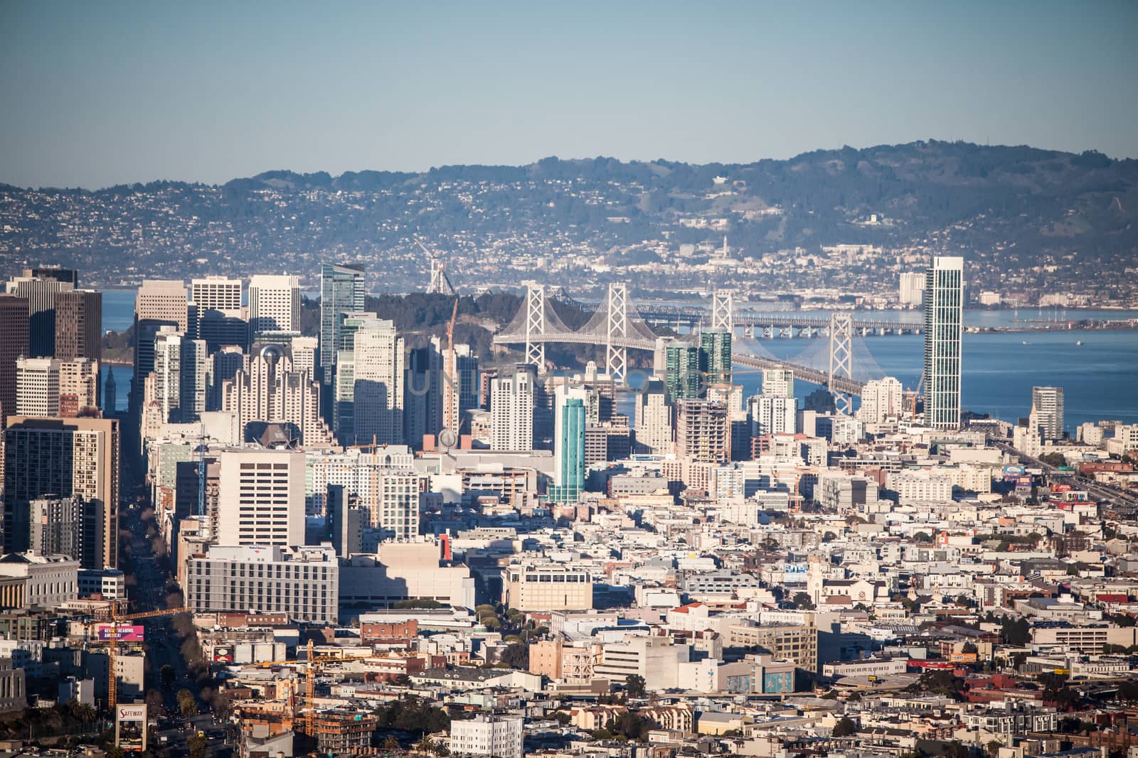 San Francisco, USA - February 14 - The Downtown area of San Francisco from Twin Peaks at sunset. The Bay Bridge to Oakland lies in the background on February 14th 2013.