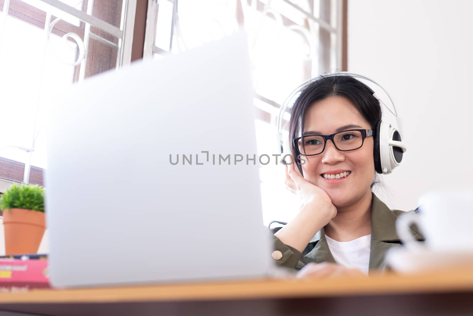 Modern young Asian woman working from home with happy, smile, and relax..