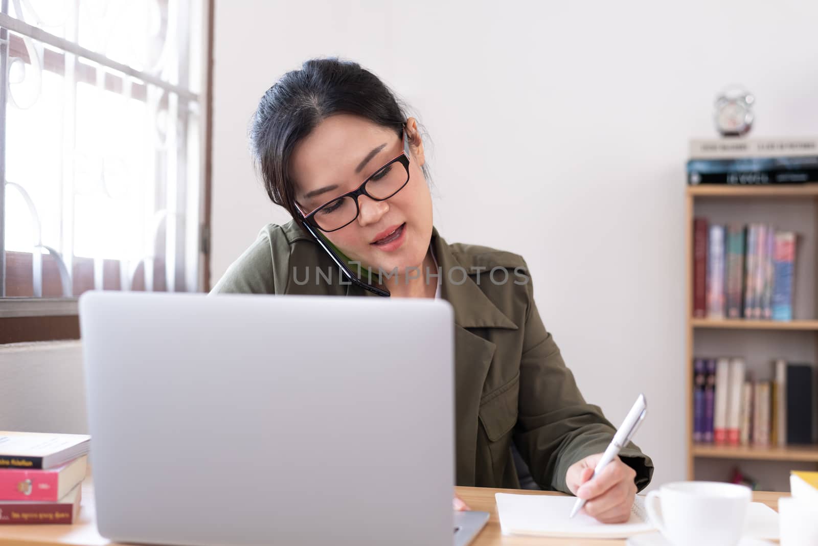 Modern young Asian woman working from home.