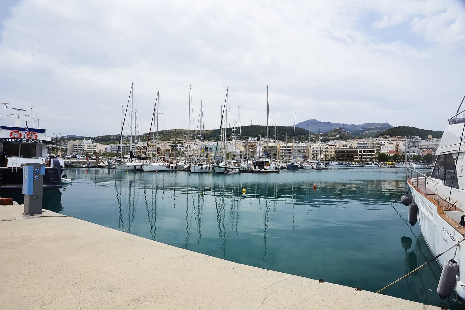 RETHYMNO, THE CRETE ISLAND, GREECE - MAY 30, 2019: Beautiful big white yachts in the seaport of the Rethymno, the Crete island, Greece