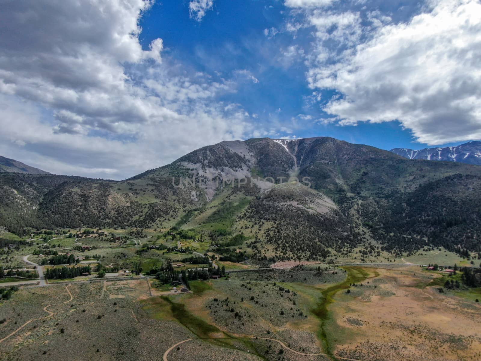 Aerial view of green land and mountain in Aspen Springs, Mono County California, USA by Bonandbon