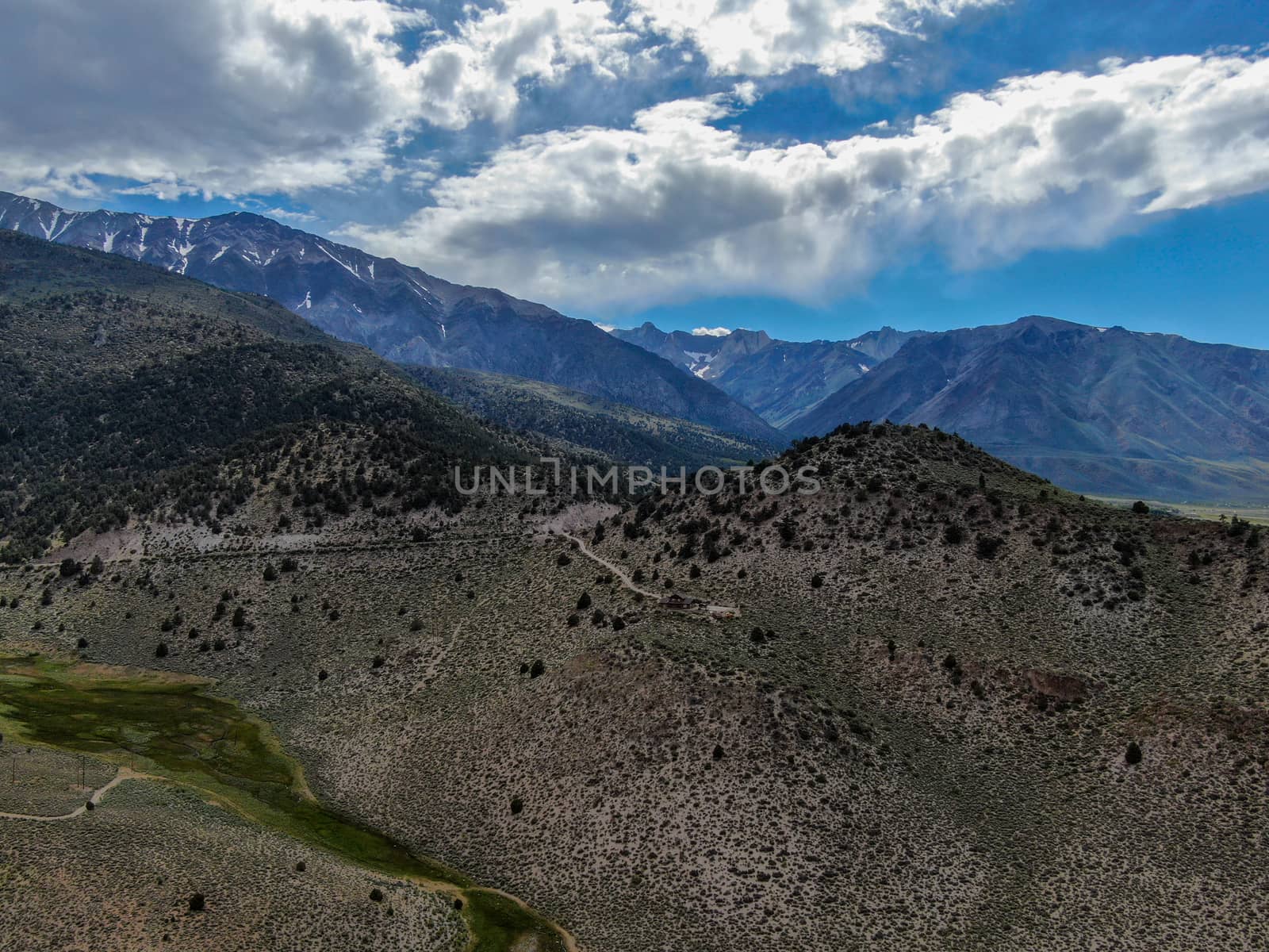 Aerial view of green land valley and mountain in Aspen Springs, Mono County California, USA