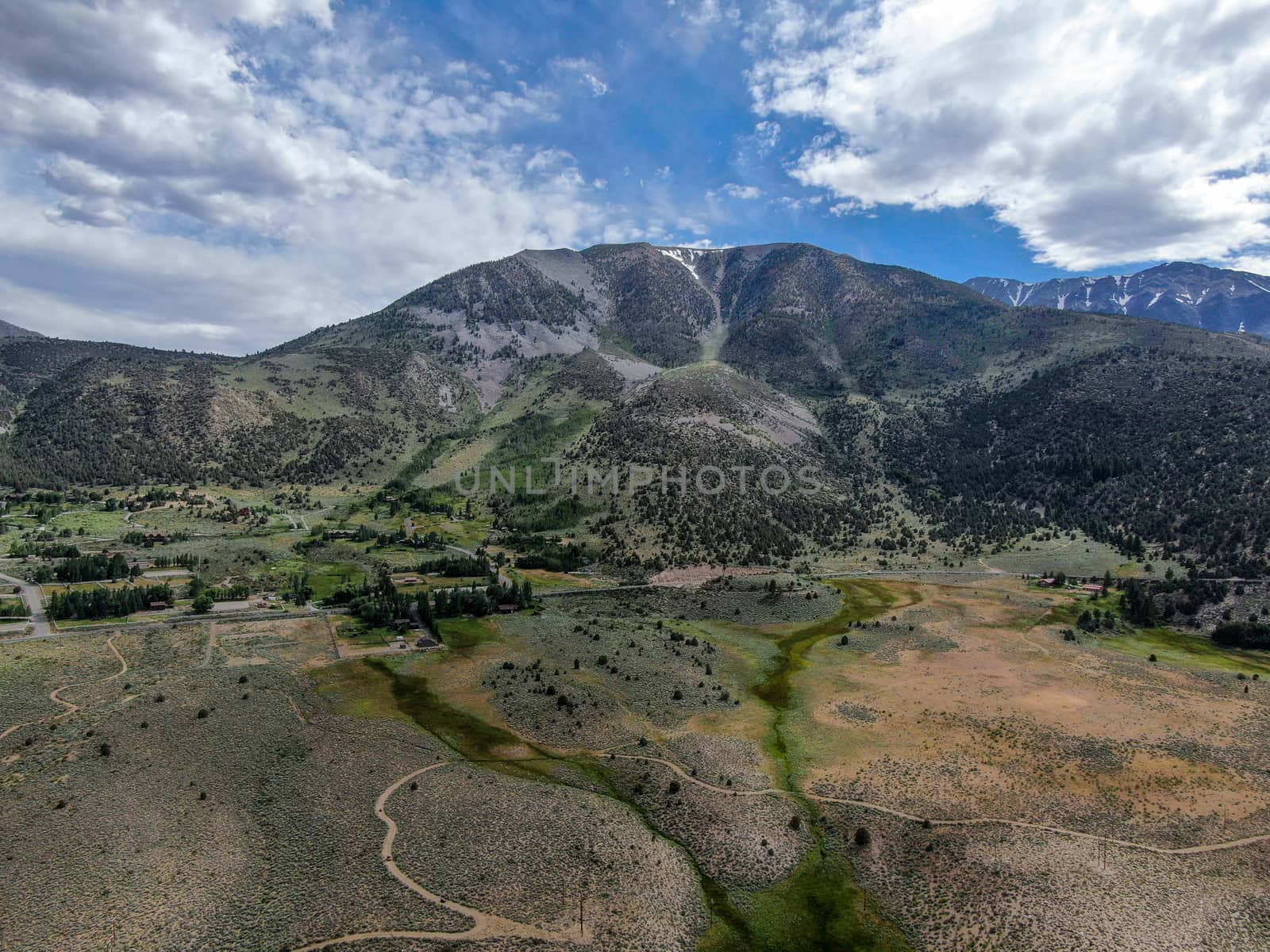 Aerial view of green land and mountain in Aspen Springs, Mono County California, USA by Bonandbon