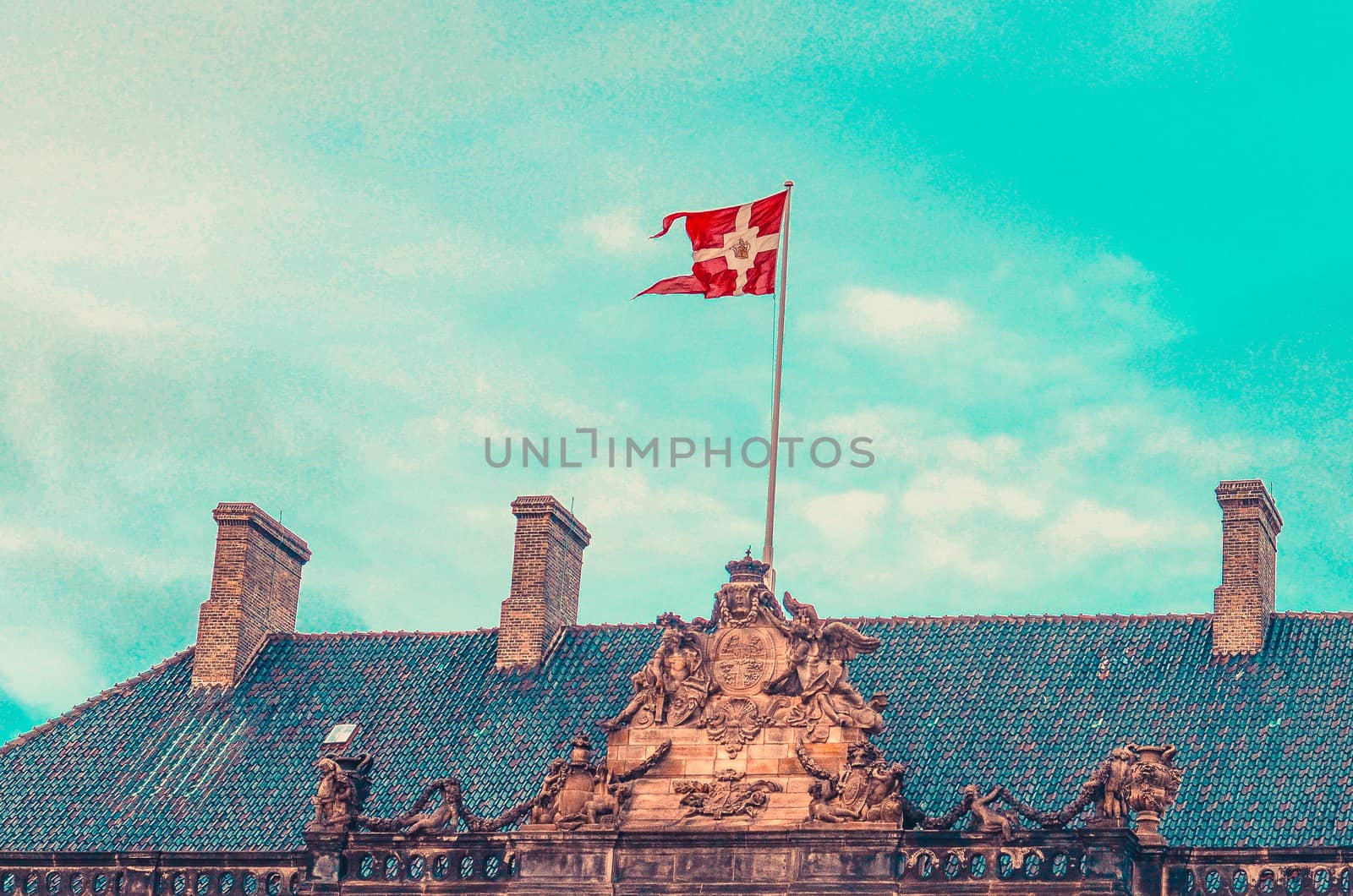 National Danish flag on the Royal Palace Amalienborg. Copenhagen, Denmark