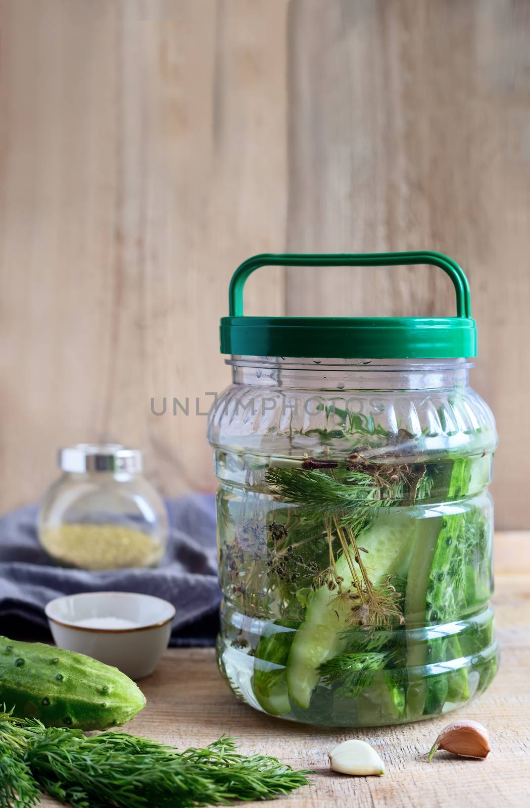 Pickles in a glass jar with cucumber brine by georgina198