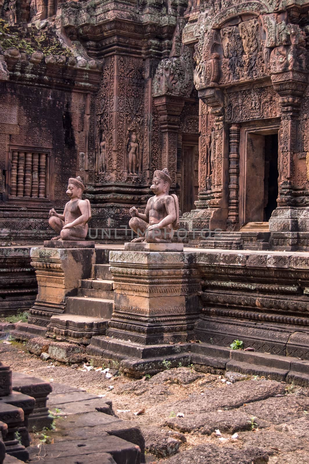 Statues of guardians outside the entrance to a chapel at Banteay Srei temple, Angkor, Cambodia.