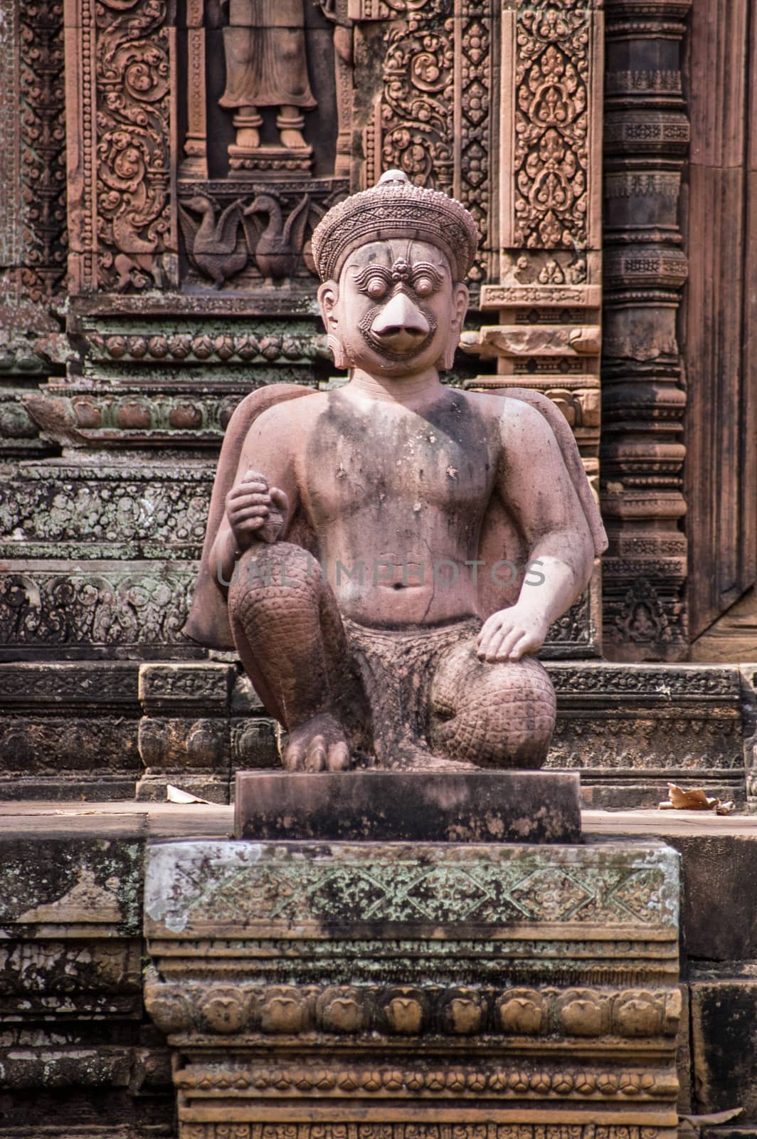Ancient Khmer statue of a bird faced deity guarding one of the Prasat chapels at the temple of Banteay Srei, Angkor, Cambodia.