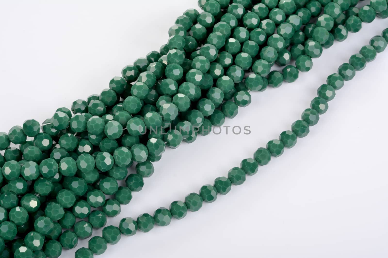 green Glass Sparkle Crystal Isoalted Beads on white background. Use for diy beaded jewelry by polyats