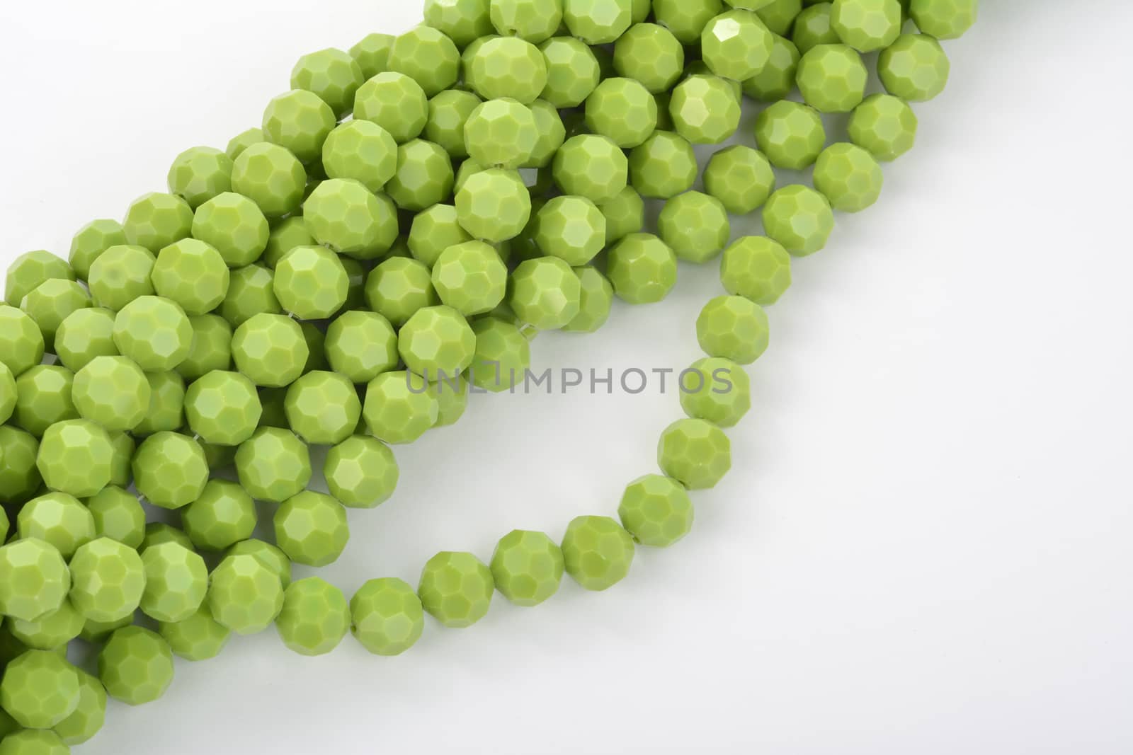 green Glass Sparkle Crystal Isoalted Beads on white background. Use for diy beaded jewelry by polyats