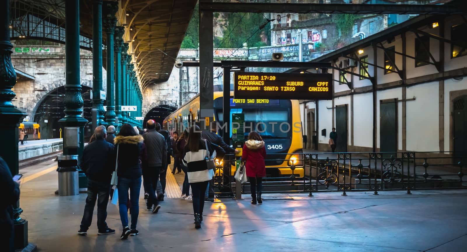 Interior of Porto train station where people walk on the dock by AtlanticEUROSTOXX