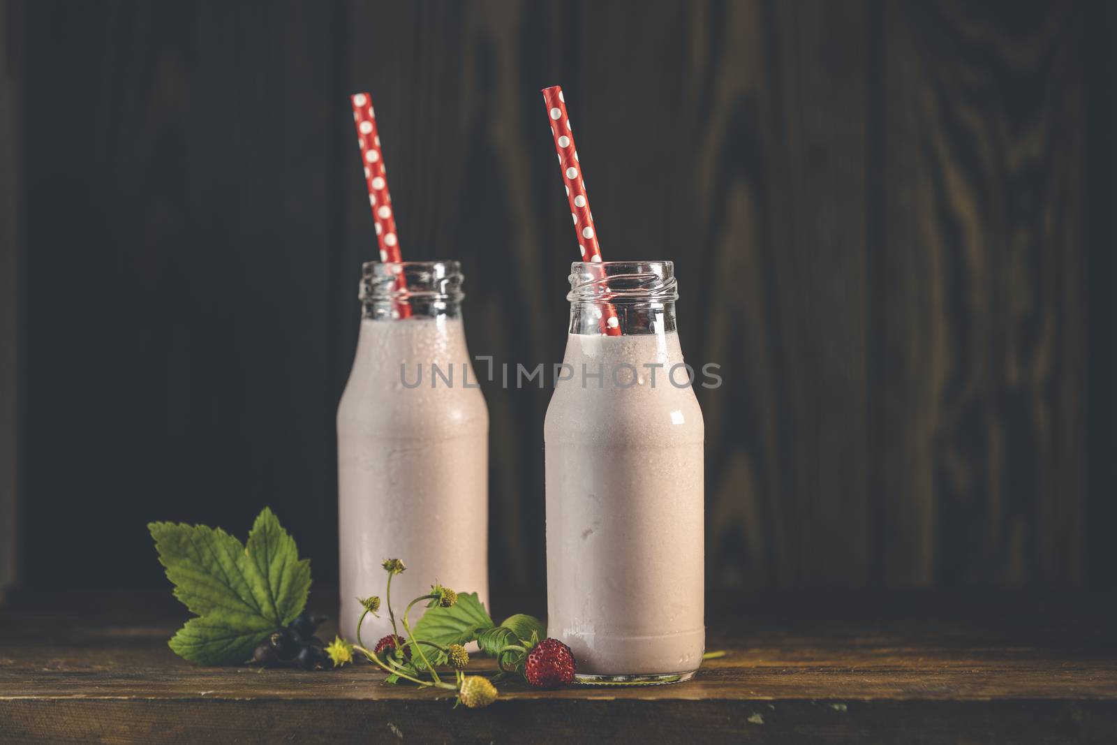 Bottles with delicious strawberry milkshake or smoothie with bra by ArtSvitlyna