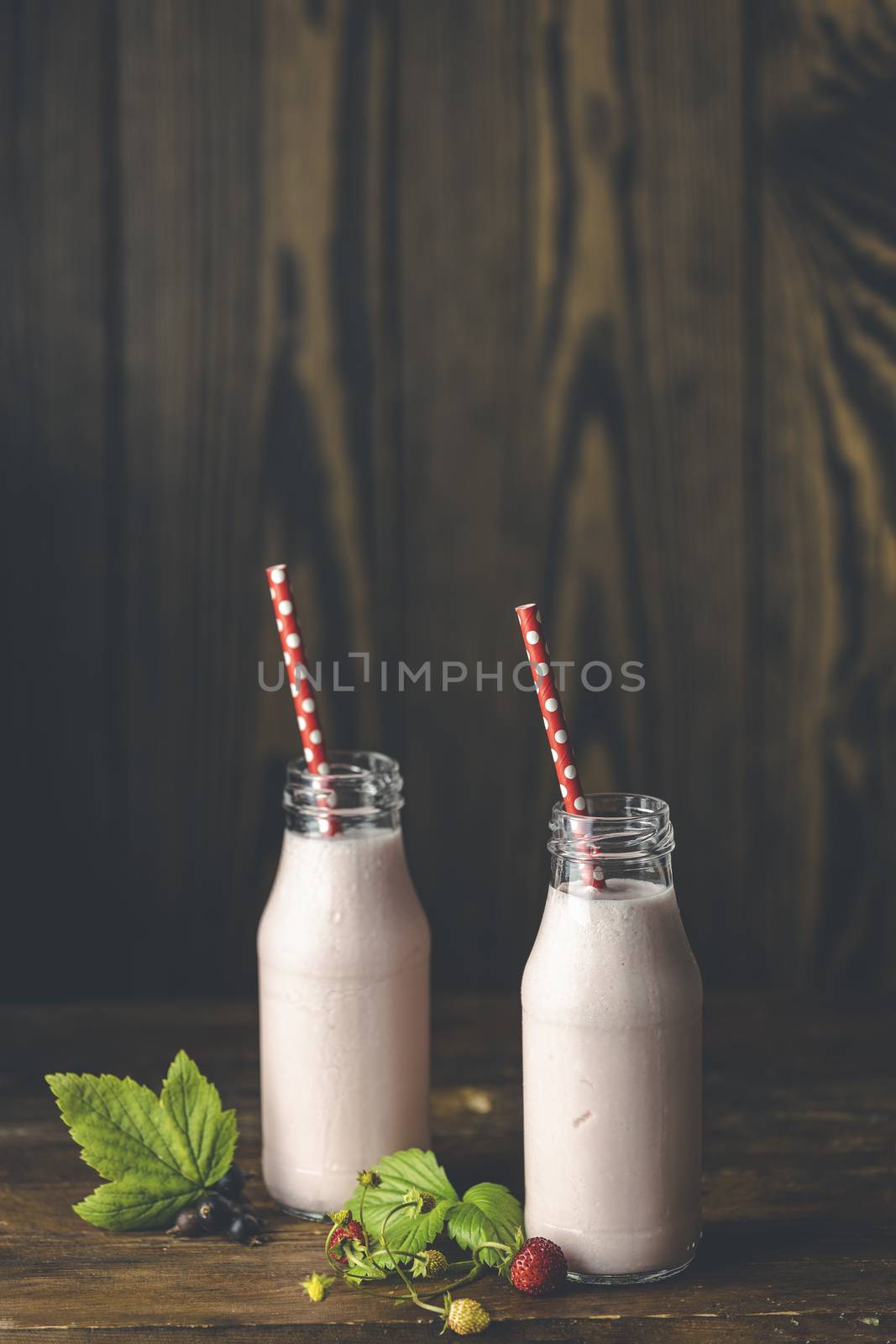 Bottles with delicious strawberry milkshake or smoothie with bra by ArtSvitlyna