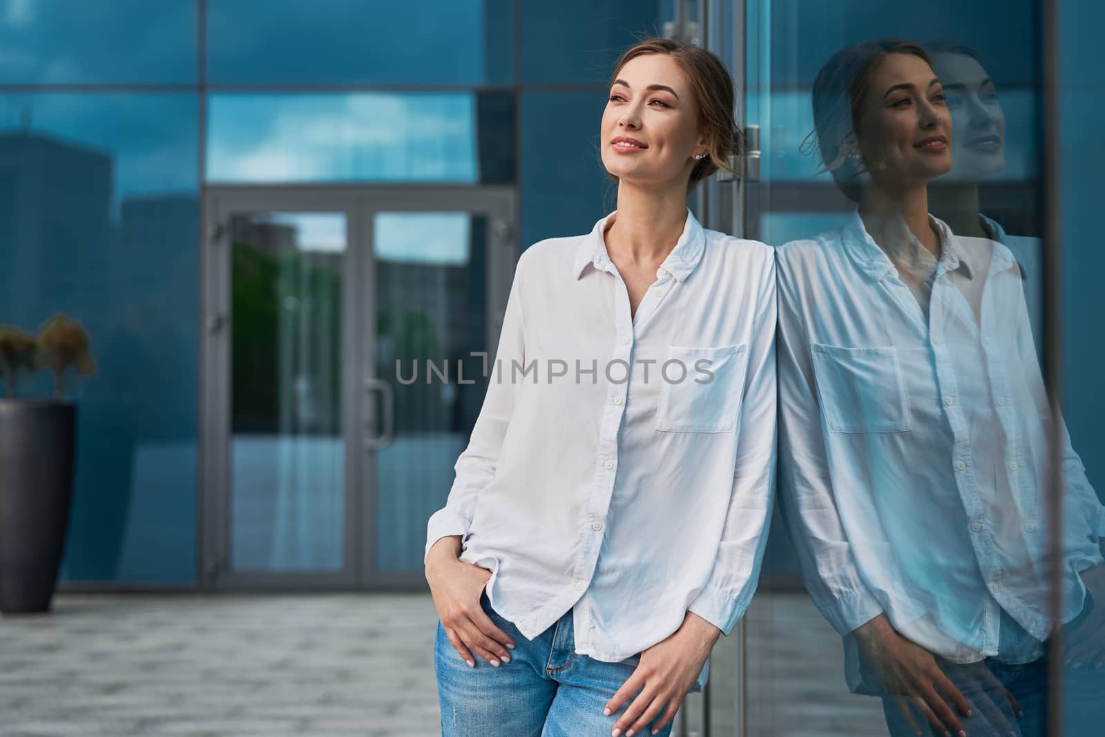 Businesswoman successful woman business person standing outdoor corporate building exterior. Pensiv caucasian confidence professional business woman middle age by andreonegin