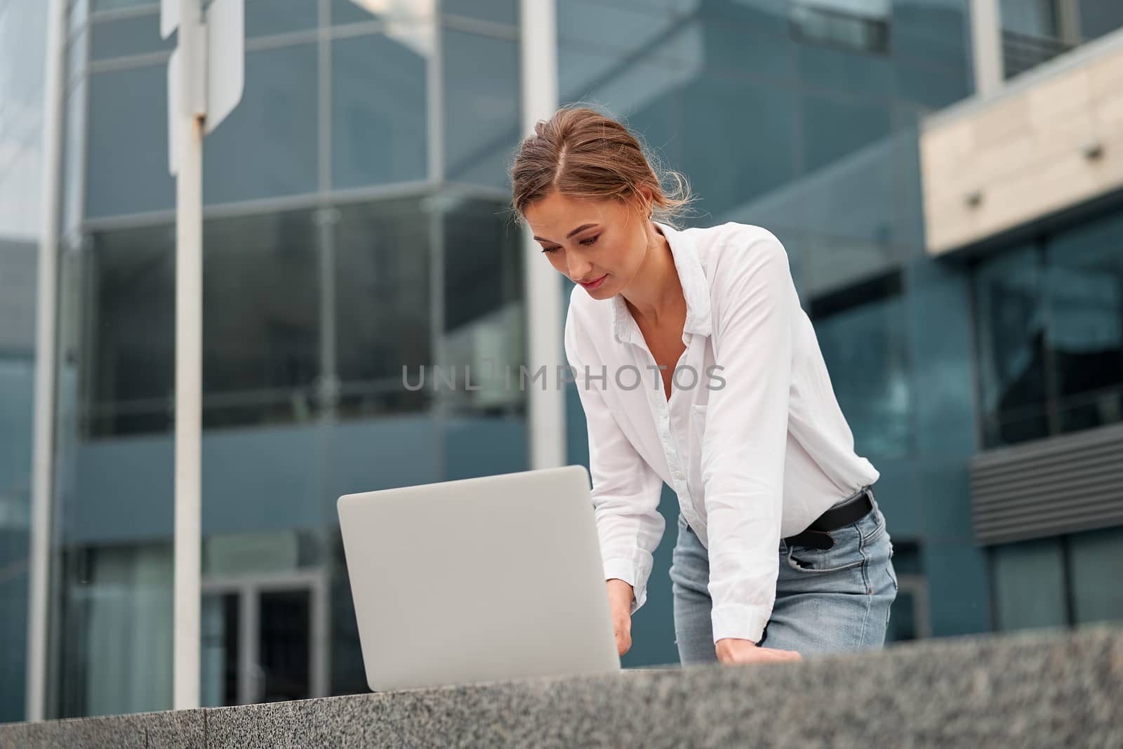 Businesswoman successful woman business person outdoor corporate building exterior with laptop Pensive elegance cute caucasian professional business woman middle age ecommerce deal Online banking