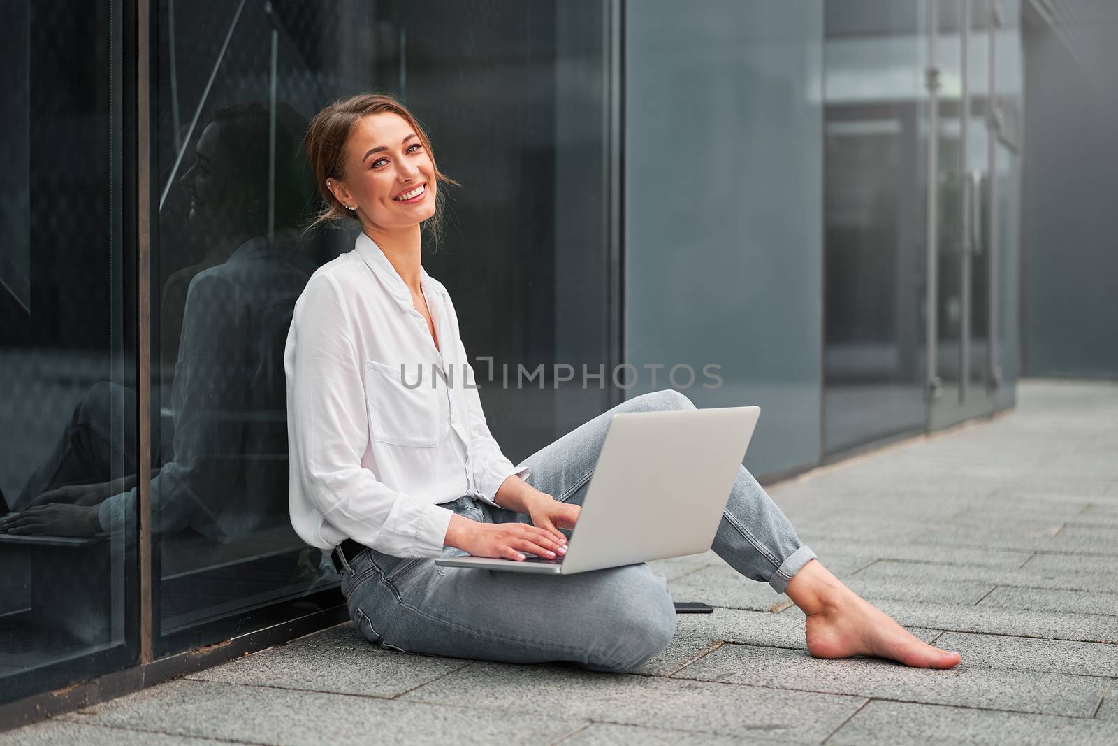 Businesswoman successful woman business person outdoor corporate building exterior with laptop Pensive elegance cute caucasian professional business woman middle age ecommerce deal Online banking