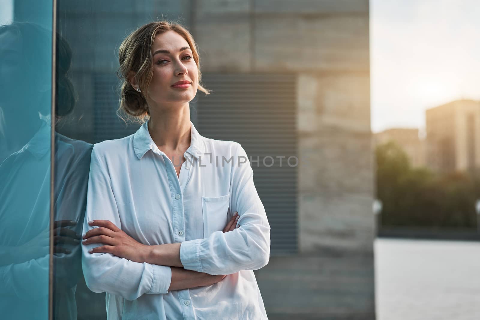 Businesswoman successful woman business person standing arms crossed outdoor corporate building exterior. Smile happy caucasian confidence professional business woman middle age by andreonegin