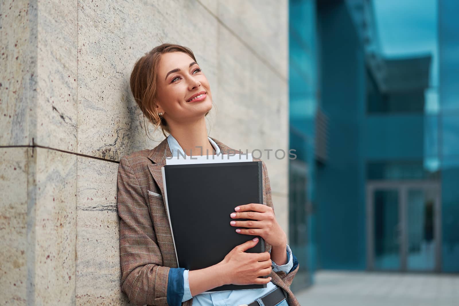 Businesswoman successful woman business person standing outdoor corporate building exterior. Pensiv caucasian confidence professional business woman middle age by andreonegin