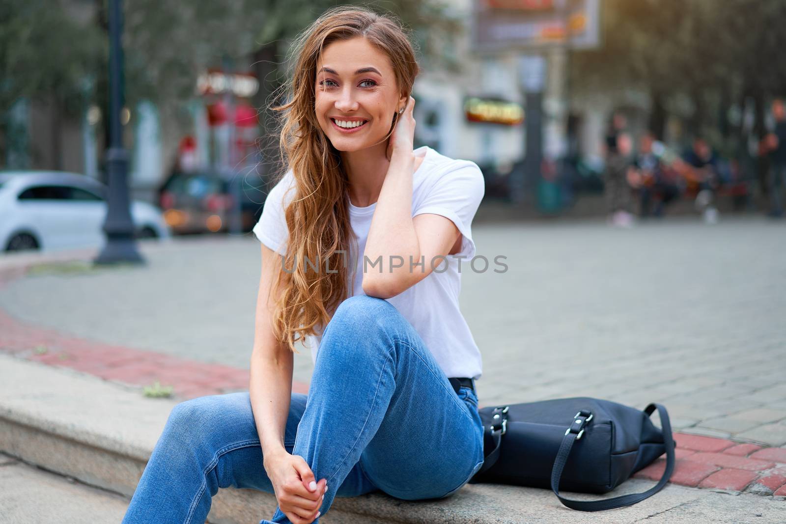 Woman city street summer sitting stairs outdoor park Modern stylish travel girl with backpack resting happy smiling on city street. Middle age female alone