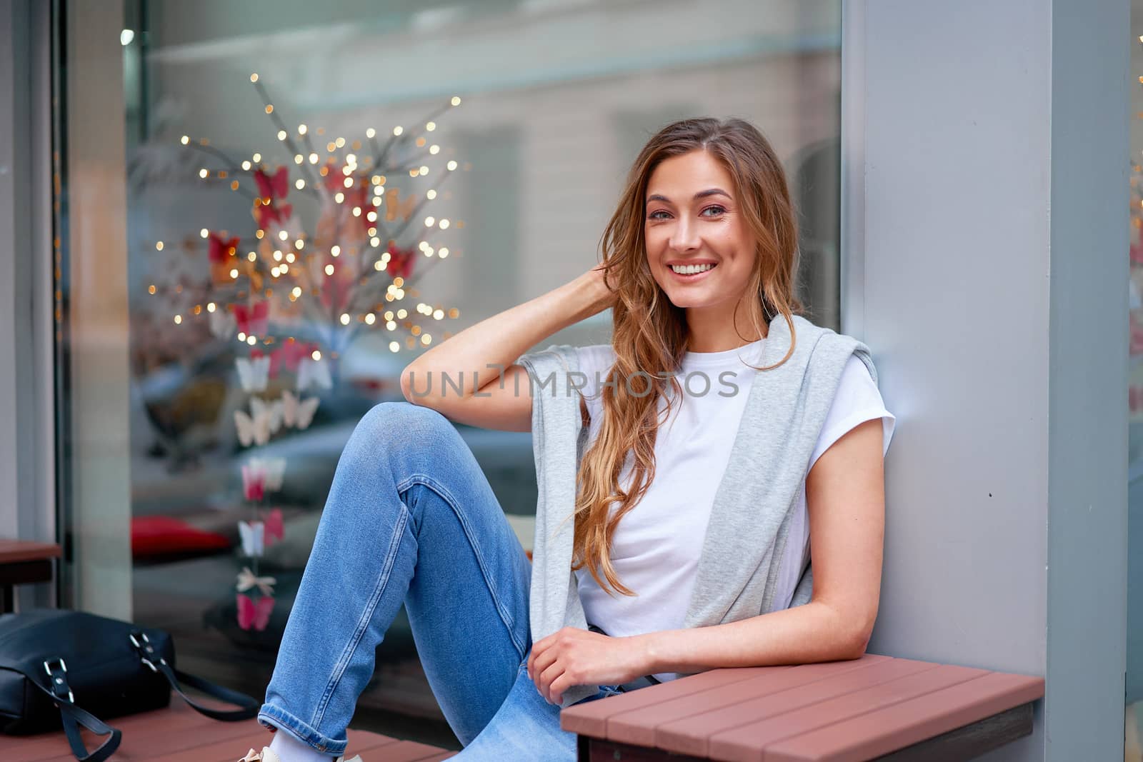 Woman city street summer sitting bench showcase shop window outdoor Modern stylish travel girl with backpack resting happy smiling on city street. Middle age female alone