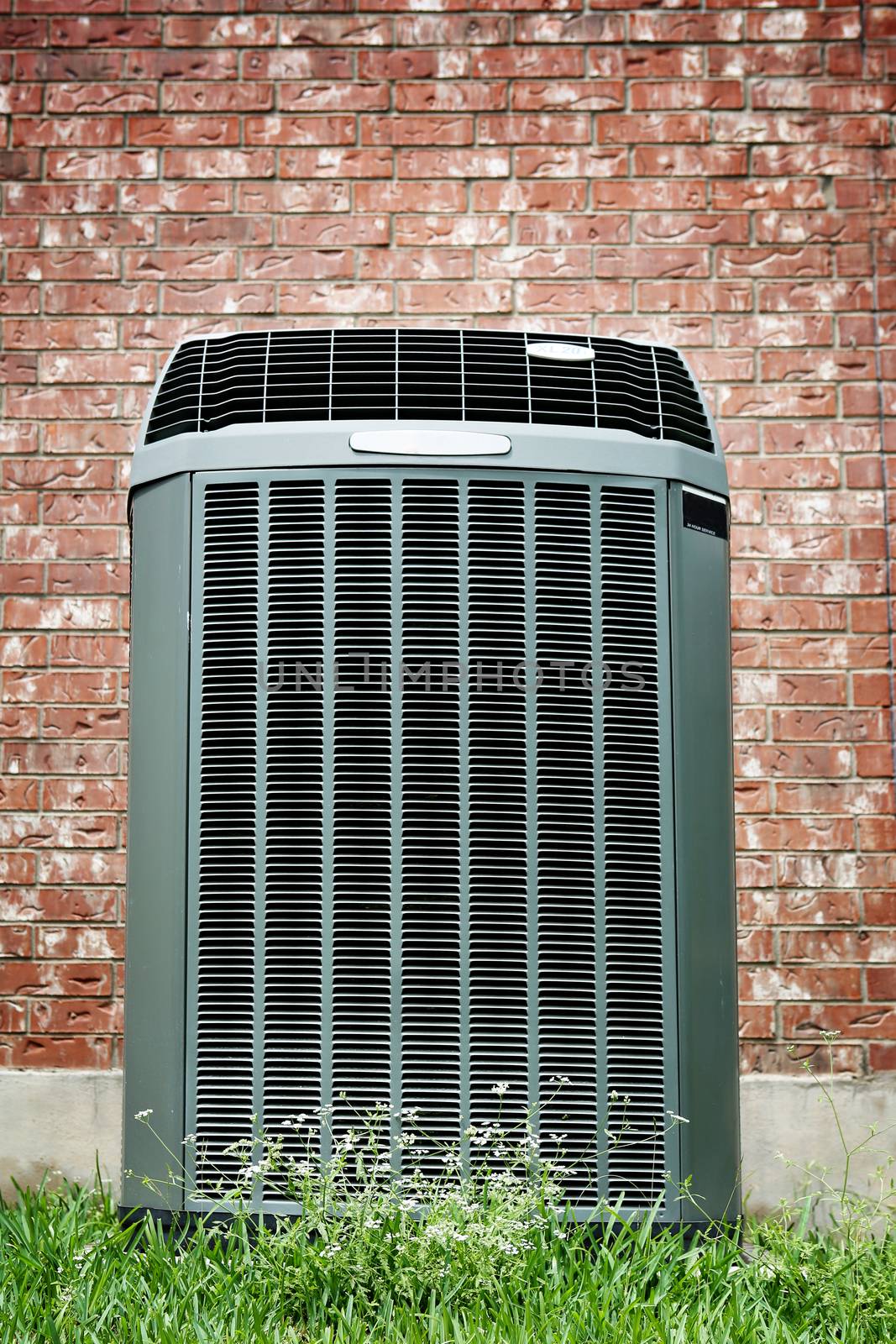 High efficiency modern AC-heater unit, energy save solution in front of brick wall